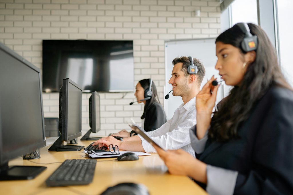 Diverse group of call center agents working together in a modern office environment.