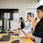 Diverse group of call center agents working together in a modern office environment.