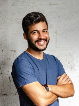 Portrait of a happy man with arms crossed, exuding confidence and friendliness.